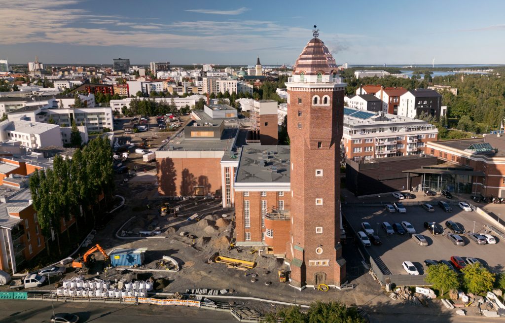 Rakennustyömaakuva kesäisenä päivänä, Etualalla näkyy suuri torni.