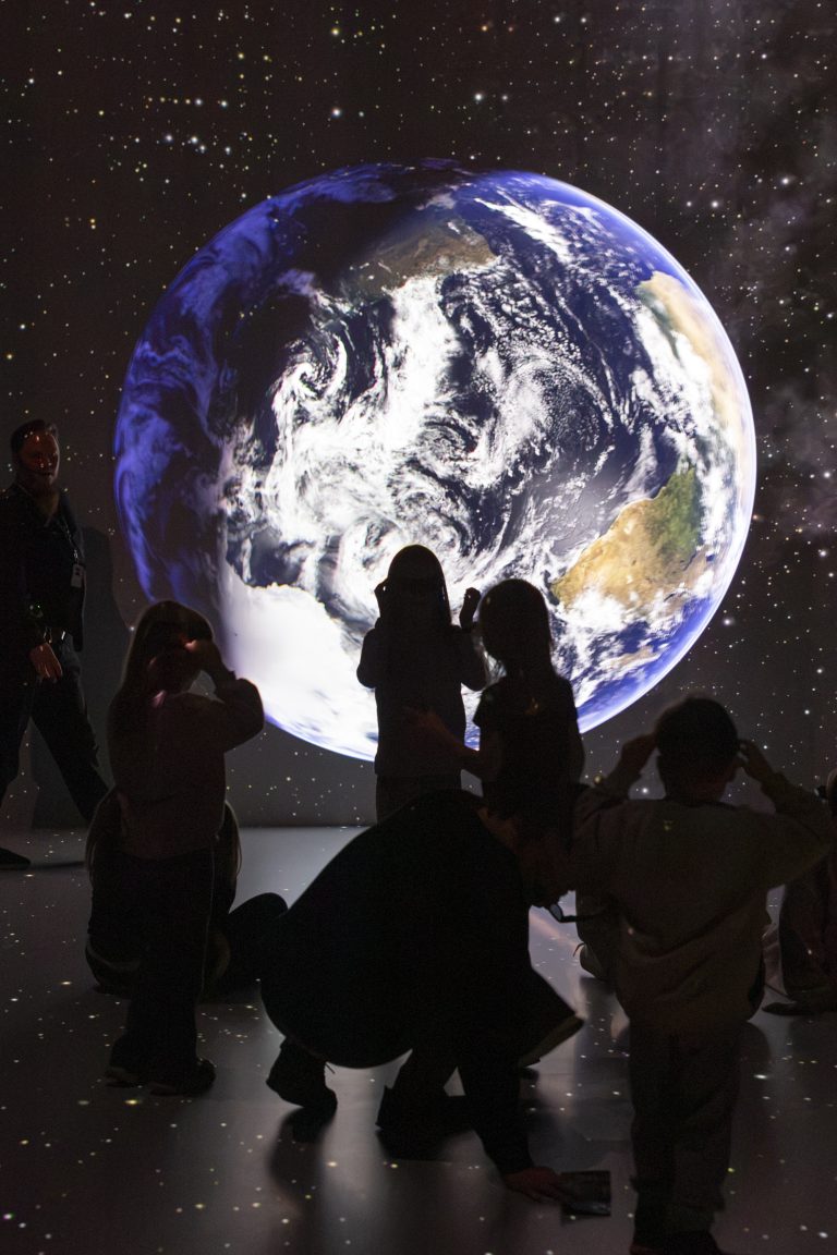 People watching a presentation projected around them.